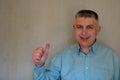 Middle aged man portrait. Thumb up gesture of 40 years man looking at camera and smiling. Blue business shirt is dressed. Happy Royalty Free Stock Photo