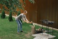 A middle-aged man prepare firewood for a barbecue in his country house Royalty Free Stock Photo