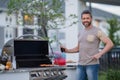 Middle aged man preparing barbecue grill outdoor. Man cooking barbecue grill at backyard. Chef preparing food on Royalty Free Stock Photo