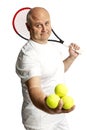 Middle aged man with racket and tennis balls. Isolated on a white background. Royalty Free Stock Photo