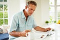 Middle Aged Man Reading Magazine Over Breakfast Royalty Free Stock Photo