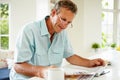 Middle Aged Man Reading Magazine Over Breakfast Royalty Free Stock Photo