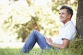 Middle Aged Man Relaxing In Countryside Leaning Against Tree Royalty Free Stock Photo