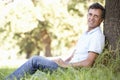 Middle Aged Man Relaxing In Countryside Leaning Against Tree Royalty Free Stock Photo