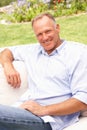 Middle Aged Man Relaxing In Garden Royalty Free Stock Photo