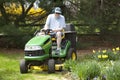 Middle-Aged Man on Riding Lawn Mower