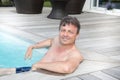 Middle aged man sit in pool relax in vaction day Royalty Free Stock Photo