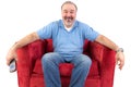 Middle-aged man sitting on a red armchair Royalty Free Stock Photo