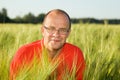 Middle-aged man smiling behind hay Royalty Free Stock Photo