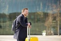 Middle aged man standing in front of the Central station at sunny spring day. Business trips