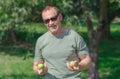 A middle-aged man stands with apples Royalty Free Stock Photo