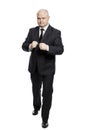 A middle-aged man in a strict black suit in a fighting stance. Full height. Isolated on white background. Vertical