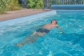 A man swims in a pool in the courtyard Royalty Free Stock Photo