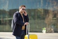 Middle-aged man talking on the phone in the background of the Central station