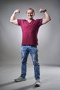 Mature man on gray background flexing muscles Royalty Free Stock Photo