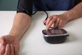 Middle aged man testing his blood pressure at home Royalty Free Stock Photo