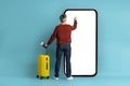 Middle aged man traveller using huge smatphone, mockup