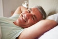 Middle Aged Man Waking Up In Bed Royalty Free Stock Photo