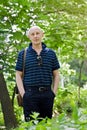 Middle-aged man walks in a summer park Royalty Free Stock Photo