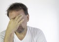 Middle-aged man with white T-shirt and quarantined boredom. Depression and anguish for social isolation