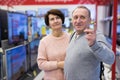 Middle aged man and woman choosing TV in electronic store Royalty Free Stock Photo