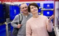 Middle aged man and woman choosing TV in electronic store Royalty Free Stock Photo