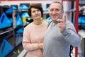 Middle aged man and woman choosing TV in electronic store Royalty Free Stock Photo