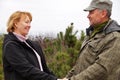 Middle aged man and woman smiling and holding hands looking at each other Royalty Free Stock Photo