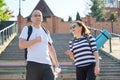 Middle-aged man and woman in sportswear talking walking