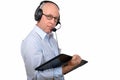 A middle-aged man working with a digital tablet and headphones Royalty Free Stock Photo