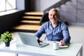 Middle-aged man working from home office on laptop Royalty Free Stock Photo