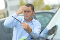 Middle-aged man working on windshield wipers