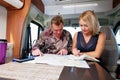 Couple talking about future adventure planning route looking at map Royalty Free Stock Photo