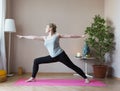 Middle aged woman doing yoga indoors