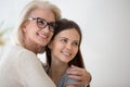 Middle-aged mother embraces adult grown up daughter Royalty Free Stock Photo