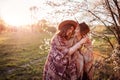 Middle-aged mother and her adult daughter hugging in blooming garden. Mother`s day concept. Family values Royalty Free Stock Photo