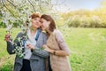 Middle-aged mother and her daughter hugging in blooming garden Royalty Free Stock Photo