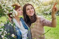 Middle-aged mother and her daughter hugging in blooming garden Royalty Free Stock Photo