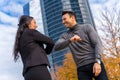 Middle-aged multi-ethnic businessman and businesswoman greeting each other outside of the office Royalty Free Stock Photo