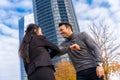 Middle-aged multi-ethnic businessman and businesswoman greeting each other outside of the office Royalty Free Stock Photo