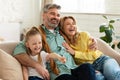 Middle Aged Parents Hugging Little Daughter Laughing Bonding At Home Royalty Free Stock Photo