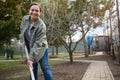 Middle aged pleasant woman gardener digs ground in the garden, loosens soil for planting vegetables. Home vegetable garden in the Royalty Free Stock Photo