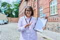 Middle-aged female school worker, teacher on background of school building Royalty Free Stock Photo