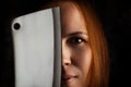 Middle aged redhead woman with butcher knife in the dark Royalty Free Stock Photo