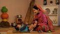 Young Indian mother massaging her newborn baby with oil - oil massage, body massage, bay care, healthy baby, child care, printing,