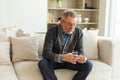 Middle aged senior man holding medical pill and glass of water. Mature old senior grandfather taking medication cure Royalty Free Stock Photo