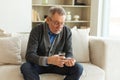 Middle aged senior man holding medical pill and glass of water. Mature old senior grandfather taking medication cure Royalty Free Stock Photo