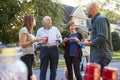 Middle aged and senior neighbours talking at a block party