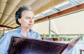 Middle-aged soft skin man looking at menu in restaurant