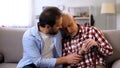 Middle-aged son comforting retiree terminally ill father, suffering pain, care Royalty Free Stock Photo